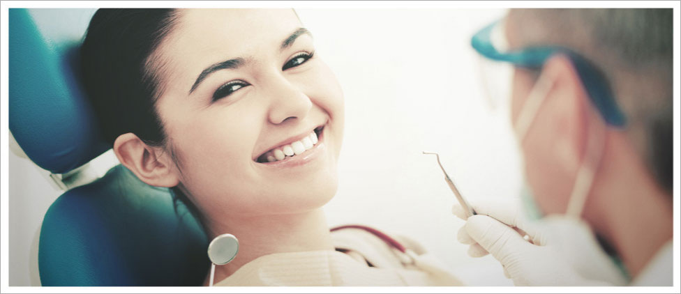 Smiling girl on dental chair